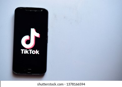 New Delhi, India - April 23, 2019:tiktok Application Logo On Mobile Phoneon White Background With Text Space.