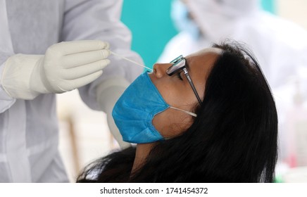 NEW DELHI, INDIA - APRIL 23, 2020: Coronavirus Covid19 Test In India, A Woman Health Worker Collect Swab Sample From A Woman For Covid 19 Test During The Lockdown To Curb The Spread Of Coronavirus.
