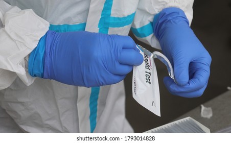 New Delhi, India August 10, 2020: Testing Stick Of Swab Sample Covid 19 Disease Outbreak, A Health Worker Wearing PPE Suit Collects Swab Sample For Coronavirus Covid-19 Rapid Antigen Test,  