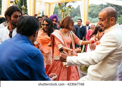 NEW DELHI, INDIA - December 8, 2015: Groom And Bride Dancing At The Indian Wedding Banquet