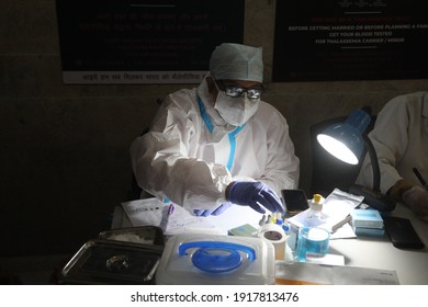 New Delhi, India, Fab 16, 2021: A Doctor Wearing PPE Kit Prepare Donors Checklist Who Donate Blood For Patients.