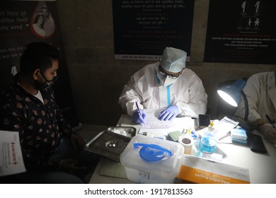 New Delhi, India, Fab 16, 2021: A Doctor Wearing PPE Kit Prepare Donors Checklist Who Donate Blood For Patients.