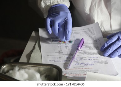 New Delhi, India, Fab 16, 2021: A Doctor Wearing PPE Kit Check Blood Group Of Blood Donors Who Donate Blood For Patients.