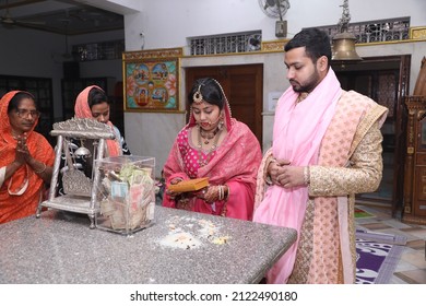 New Delhi, India - Feb 07 2020: A Newly Wedded Couple Praying In Jain Temple Asking The Blessings From The God. Indian Groom Dressed In Ivory Sherwani And Stunning Bride Pink Lehenga. Indian Wedding.