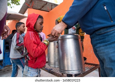 New Delhi, India - February 20, 2020: A Kid In A Queue Taking Food At A Free Food Distribution Centre Set Up By An NGO.