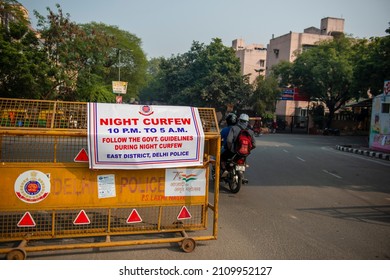 New Delhi, India- Jan 01 2022: A Banner Of Night Curfew Timings Placed On A Police Barricade. 