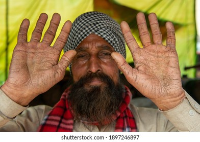 New Delhi, India, January 18 2020: Shows His Rough Hands To Manifest The Tough Life Of An Indian Farmer. Who Works In The Fields. Farmers Agitation At Ghazipur Border.