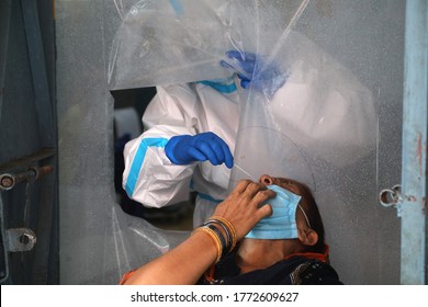 New Delhi, India, July 08, 2020: A Medic Wears Ppe Kit Collect Swab Sample From A Woman For Coronvirus Covid 19 Test To Slow The Spread The Coronavirus Disease.