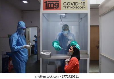 New Delhi, India, July 08, 2020: Covid19 Test, Health Worker In PPE Kit Coveralls Collects Swab Sample From A Woman For Covid-19 Rapid Antigen Test To Slow The Spread Of Coronavirus Disease Covid19.