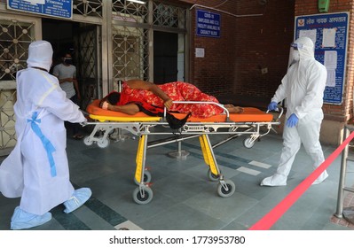 New Delhi, India, July 11, 2020: Covid19 Patient In Delhi, A Health Worker With Relative Wearing Ppe Kit Carry Of Covid-19 Woman Patient On A Stretcher At City Hospital In Delhi, India, 