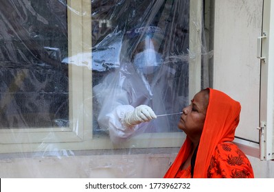 New Delhi, India, July 11, 2020: Covid19 Test In Delhi India, Medic Wear PPE Suits Collects Swab Sample From The Nose Of A Woman For COVID-19 Test Via Rapid Antigen, To Curb The Spread Of Coroavirus.