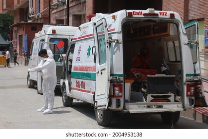 New Delhi, India, July 9, 2021: A Covid-19 Patient Transport In Ambulance By Health Worker Who Wear PPE Kit At A Covid Care Hospital In Delhi.