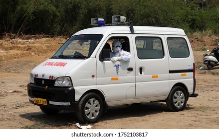 NEW DELHI, INDIA, June 09, 2020: Indian Health Worker Wear PPE Kit COVID Warrior Sit In Ambulance Carrying Who Died Form The Coronavirus Disease COVID-19 Designated Spot For COVID-19 At A Cemetery