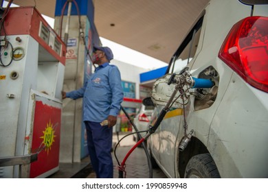 New Delhi, India- June 11 2021: An employee Handle CNG Gas dispenser for refuel CNG Vehicle fueling facility at CNG pump station in New Delhi,