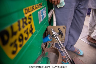 New Delhi, India- June 11 2021: dispenser for refuel Vehicle fueling facility,  refuels a vehicle with CNG gas station in New Delhi,