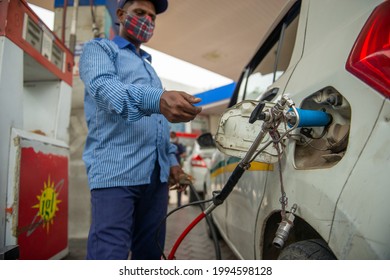 New Delhi, India- June 11 2021: An employee Handle CNG Gas dispenser for refuel CNG Vehicle fueling facility at CNG pump station in New Delhi,
