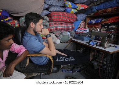 New Delhi, India - June 14, 2019 - Shopkeepers Use A Smartphone To Watch The ICC Cricket World Cup Match Between India And Pakistan, In New Delhi.