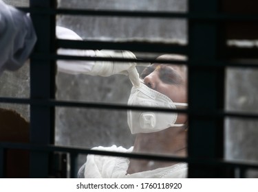 New Delhi, India, June 20, 2020:  Health Worker Takes A Sample Of A Young Woman For COVID-19 Ag Rapid Antigen Test At Govt School.