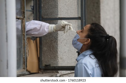 New Delhi, India, June 20, 2020:  Health Worker Takes A Sample Of A Young Woman For COVID-19 Ag Rapid Antigen Test At Govt School.