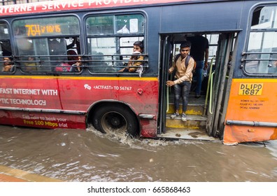 NEW DELHI, INDIA. JUNE 21,2017. : Rain In Delhi. A Man Tries To Get Off A City Bus, But Is Stuck Due To Heavy Rains In Delhi, Thus Leading To Waterlogged Roads. 