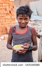 New Delhi, India - June 23, 2019: A young poor boy with his bowl of food in the capital city of India. 20% of the population or 220 million people in India are below poverty line