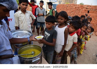 New Delhi, India - June 23, 2019: An NGO Feeding Poor Kids In A Slum Area In The National Capital. Today, The Poverty Rate In India Is 21 Percent, Which Is An Improvement From The 31.1 Percent In 2009