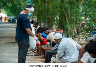 New Delhi/ India  - June13 2020 , Man Help To Sanitize Hand Before Serving Meal To Poor And Hungry People Outside LNJP Hospital 