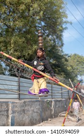 New Delhi, India - March 16 2019: A Girl Walking On Tight Rope In City Street.