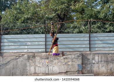 New Delhi, India - March 16 2019: A Girl Walking On Tight Rope In City Street.