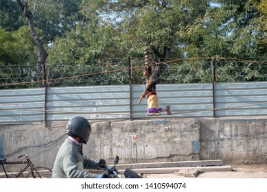 New Delhi, India - March 16 2019: A Girl Walking On Tight Rope In City Street.