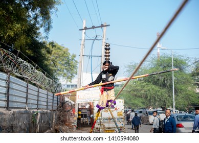 New Delhi, India - March 16 2019: A Girl Walking On Tight Rope In City Street.