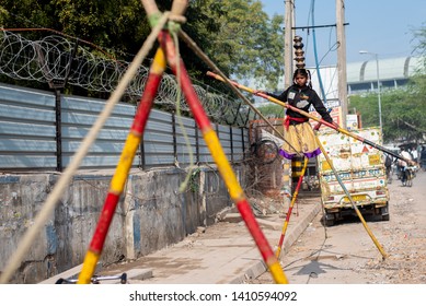 New Delhi, India - March 16 2019: A Girl Walking On Tight Rope In City Street.