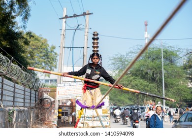 New Delhi, India - March 16 2019: A Girl Walking On Tight Rope In City Street.