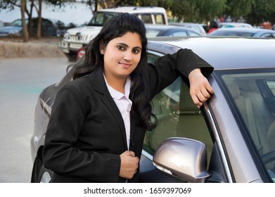 New Delhi, India - March 16, 2014:Confident Young Women Of Indian Ethnicity Standing Portrait Near Car Wearing Business Suit.