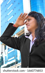 New Delhi, India - March 16, 2014:Cheerful Young Women Of Indian Ethnicity Standing Near Business Buildings & Looking Away.