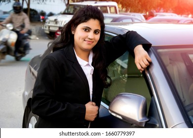 New Delhi, India - March 16, 2014:Confident Young Women Of Indian Ethnicity Standing Portrait Near Car Wearing Business Suit.