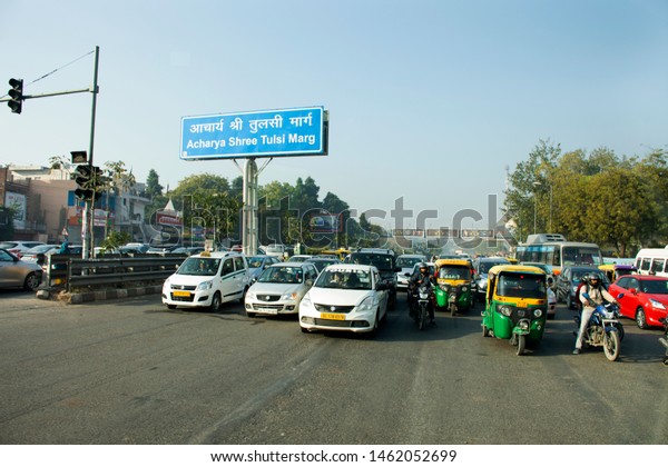 NEW DELHI, INDIA - MARCH 18 : Indian people and\
foreigners drive car and ride motorcycle and bike bicycle on the\
main road with traffic jam at New Delhi city on March 18, 2019 in\
New Delhi, India