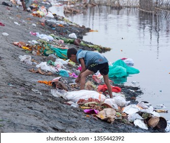 New Delhi, India - March 26, 2019: A Young Rag Picker Picking Up Garbage Near The Bank Of River Yamuna.