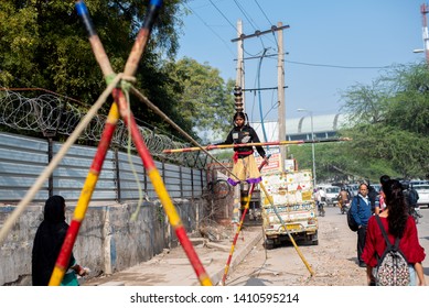 New Delhi, India - May 16 2019: A Girl Walking On Tight Rope In City Street.