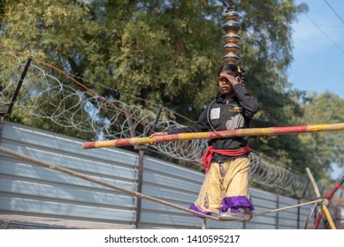 New Delhi, India - May 16 2019: A Girl Walking On Tight Rope In City Street.