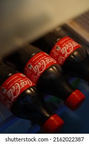 New Delhi, India - May 2022 : Close Up Shot Of Coca Cola Soft Drink 500ml Bottles Inside Fridge.