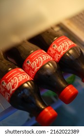 New Delhi, India - May 2022 : Close Up Shot Of Coca Cola Soft Drink 500ml Bottles Inside Fridge.