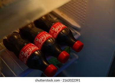 New Delhi, India - May 2022 : Close Up Shot Of Coca Cola Soft Drink 500ml Bottles Inside Fridge.