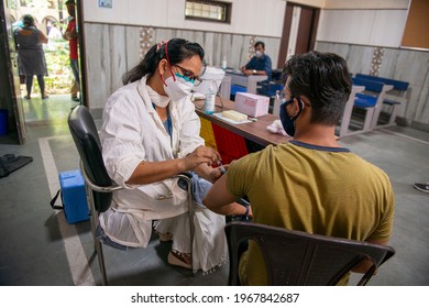 New Delhi, India, May 3 2021: vaccination in india, Young boy being vaccinated at a Mass Vaccination drive  while Third phase Of Covid-19 Mass Vaccination Drive For People Above 18 Begins In Delhi.