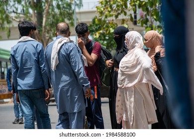 New Delhi, India, May 31 2021: Migrant Muslim Family With Bag Searching Auto Rickshaw On The Roads Of Delhi Near Anand Vihar Bus Terminal During Lockdown