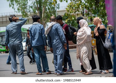 New Delhi, India, May 31 2021: Migrant Muslim Family With Bag Searching Auto Rickshaw On The Roads Of Delhi Near Anand Vihar Bus Terminal During Lockdown