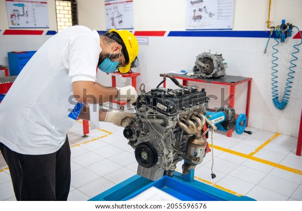 New Delhi, India- oct 5 2021: Student assembling\
diesel Engine during auto repairing training class at Industrial\
Training Institute Nizamuddin, post secondary schools in India for\
industrial training