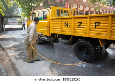 New Delhi, India - October 26 2016: Man Cleaning The Tyres  Of  Zoo Vehicle To Maintain Hygiene During Bird Flu Infection.