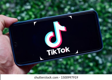 New Delhi, India - September 08, 2019: Tik Tok App On Hand In Mobile Against Green Background