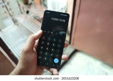 New Delhi, India - September 2021 : Close-up View Of A Man Using Calculator App On Mobile Phone. .